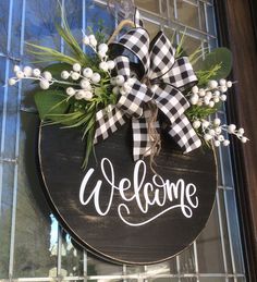 a welcome sign hanging on the front door