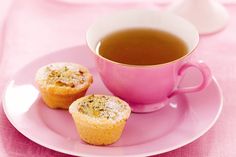 a cup of tea and some muffins on a plate