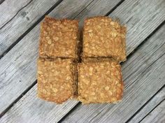 four squares of oatmeal sitting on top of a wooden table