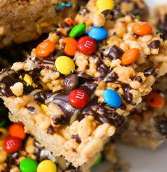 some cereal bars are on a plate with m & m candies all over them