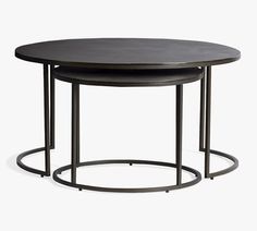 two round tables with metal bases and black wood tops, one on each side by the other