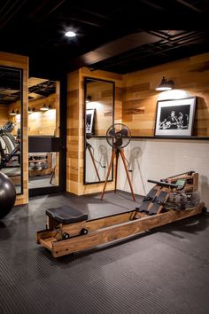 an exercise room with machines, mirrors and other things on the wall in front of it