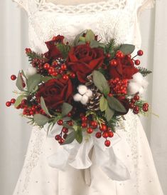 a bridal bouquet with red roses and berries