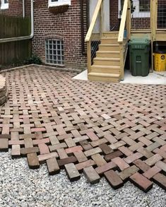 a brick patio with steps leading up to it