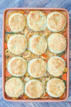 a casserole dish with eggs and vegetables in it on a blue wooden table