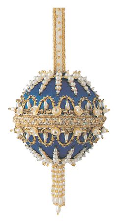 an ornate blue and gold ball hanging from a ceiling fixture with crystal beads on it