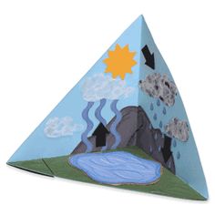 an origami pyramid with water and clouds on it