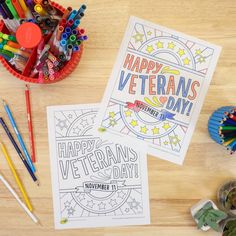 two happy veterans day coloring pages next to markers and pencils on a table with other items