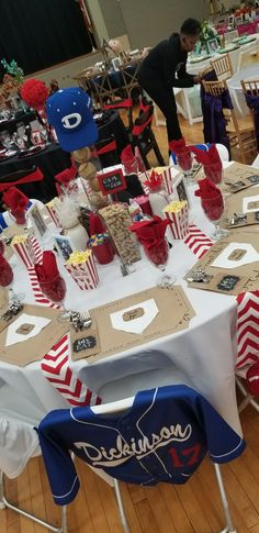 a table set up for an event with red, white and blue decorations on it