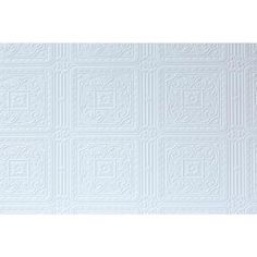 a white wall with an intricate design on it