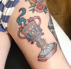 a woman's arm with tattoos on it and an image of a clock in the middle