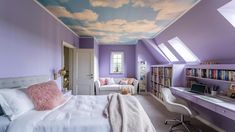 a bedroom with a sky painted on the ceiling and purple walls, along with white furniture