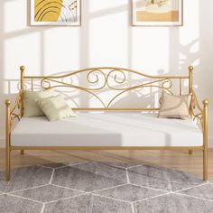 a gold metal daybed in a white room