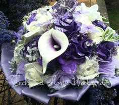 a bridal bouquet with purple and white flowers