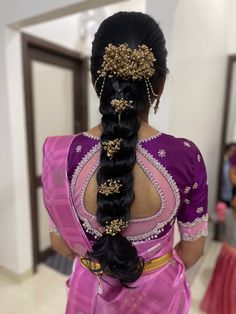 a woman with long black hair in a pink sari