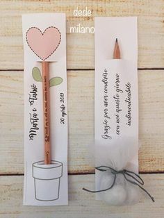 two bookmarks with pencils in them sitting next to each other on a table