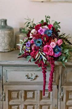 a bouquet of flowers sitting on top of a dresser