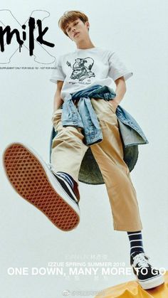 a young man is jumping in the air with his feet on a skateboard and wearing khaki pants