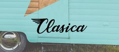 the word classica written in black ink on an old blue trailer