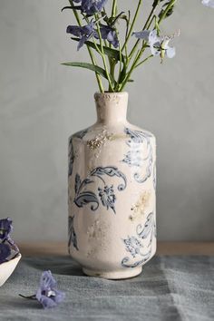 a vase with flowers in it sitting on a table