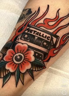 an old school style tattoo with a cassette on fire