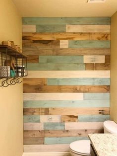 a bathroom with wood planks on the wall