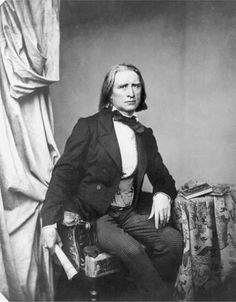 an old black and white photo of a man in a suit sitting on a chair