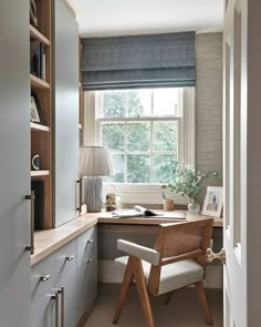 a home office with built in bookshelves, desk and chair by the window