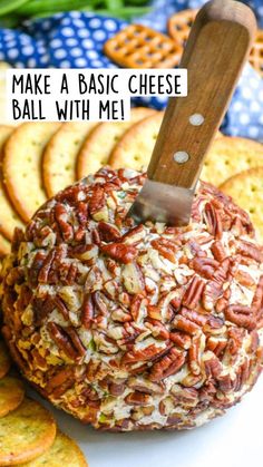 a cheese ball covered in pecans with a knife stuck into it