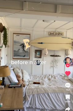 a bed room with a neatly made bed and a surfboard hanging from the ceiling