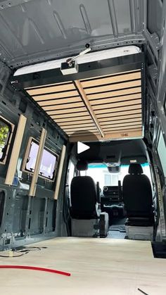 the inside of an empty van with two televisions