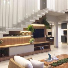 a living room filled with furniture and a flat screen tv on top of a wooden shelf