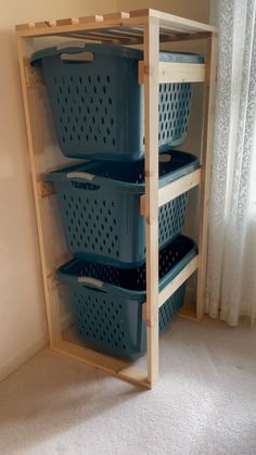 three plastic baskets are stacked on top of each other in the corner of a room