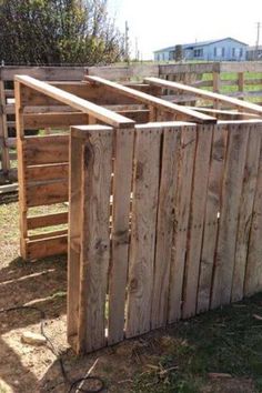 a wooden fence that has been made out of pallets and is being used as a planter