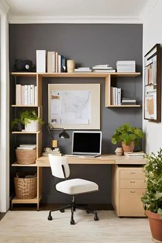 a desk with a computer on top of it next to a potted plant and bookshelf