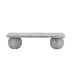 a concrete bench sitting on top of a white wall