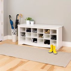 a white shoe rack sitting on top of a hard wood floor