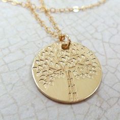 "This necklace is gorgeous and unique! A Tree of Life has been hand stamped one leaf at a time on an 20 gauge 5/8\" 14k gold fill disc. (5/8\" = approximately 16mm; slightly smaller than a nickel) Each Tree of Life will vary slightly from the picture shown--the hand stamping of the Tree of Life is an organic process and no two trees will be exactly the same. The pendant is paired with a delicate 14k gold fill cable chain in your choice of length--up to 30\"! Great for layering! Gold fill is of b Everyday Gold Nature-inspired Jewelry, Nature-inspired Everyday Gold Jewelry, Everyday Nature-inspired Gold Jewelry, Nature-inspired Nickel Free Gold Necklace, Nature-inspired Recycled Gold Jewelry For Gifts, Nature-inspired Recycled Gold Jewelry Gift, Nature-inspired Yellow Gold Nickel-free Jewelry, 14k Gold Tree Of Life Jewelry Gift, Gold Tree Of Life Nature-inspired Jewelry