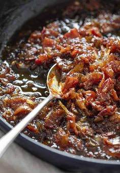 a pan filled with food and a spoon in it