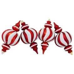 red and white striped glass ornaments are arranged in a row on top of each other