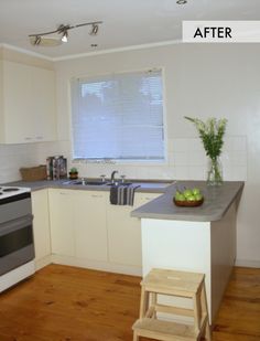 a kitchen with white cabinets and wooden floors