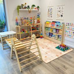 a child's playroom with wooden toys and bookshelves on the floor