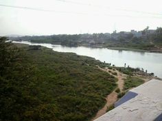 a river running through a lush green countryside