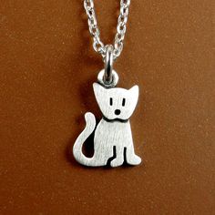 This sweet little kitten is made of sterling silver.  The pendant is TINY, measuring just under 1/2" (1.1 cm) from the tip of the ears to the bottom of the feet. (1.1 cm).  So cute You can purchase just the pendant/charm, or complete the necklace with a sterling silver chain.  For the matching kitten earrings: www.etsy.com/listing/77337863/tiny-kitten-earrings © Stick Man Creations This is our own original design, handcrafted by us, and signed on the back with our logo.   For more information ab Handmade Cute Sterling Silver Charm Necklaces, Cute Sterling Silver Pendant Charm Necklace, Cute Sterling Silver Pendant Charm Necklaces, Cute Hypoallergenic Silver Charm Necklaces, Cute Silver Sterling Silver Charm Necklaces, Cute Hypoallergenic Sterling Silver Necklaces, Cute Hypoallergenic Sterling Silver Necklace, Cute Nickel-free Silver Charm Necklace, Cute Silver Nickel-free Charm Necklaces