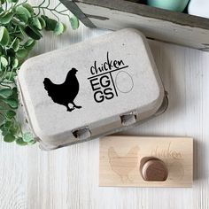 a chicken egg box next to a rubber stamp