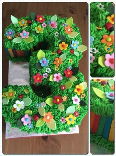 there is a cake that looks like the letter e made out of grass and flowers