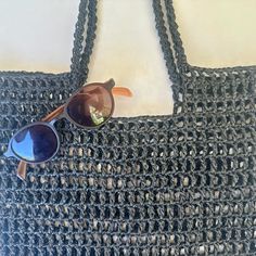 a crocheted black purse with sunglasses on it