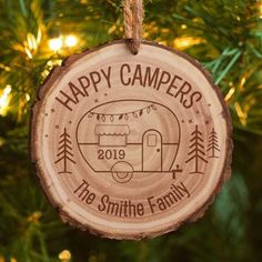 a wooden ornament hanging from a christmas tree with the words happy campers on it