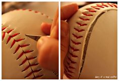 a person cutting into a baseball with a pair of scissors