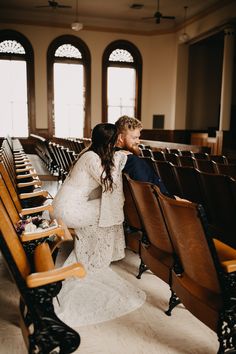 a bride and groom are sitting in the pews at their wedding ceremony, looking into each other's eyes